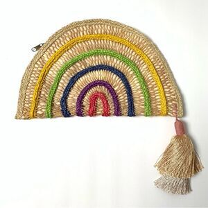 Nannacay handwoven straw clutch with pom pom tassel and zip top closure.